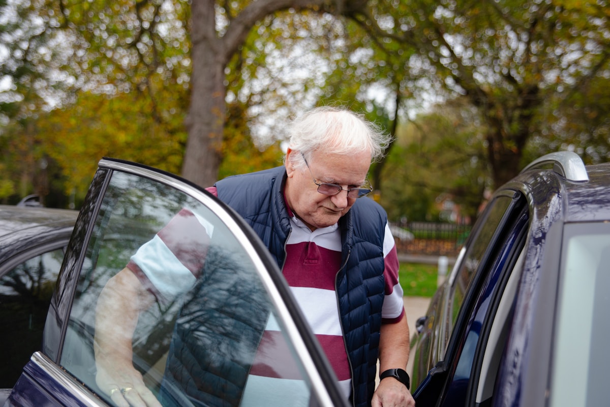 Driver assisting senior at vehicle door